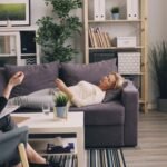 A therapist and patient in a modern office during a counseling session.